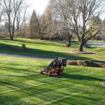 A Carrington Lawn & Landscape staff doing a landscape maintenance mowing a large garden in Middleton, WI